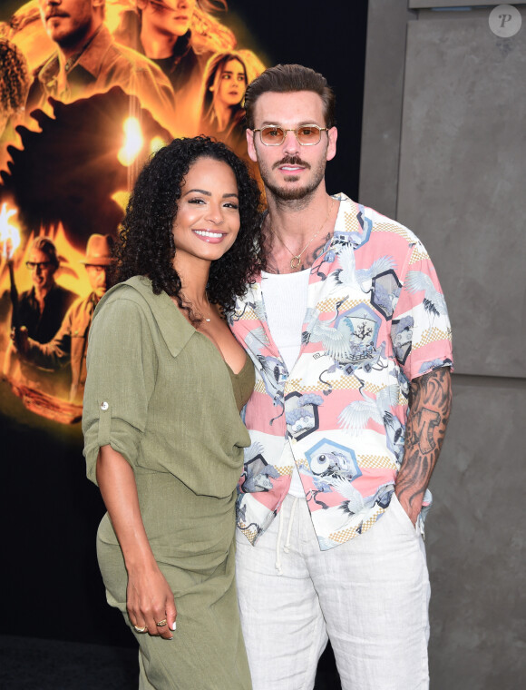 Désormais, Christina Milian et M. Pokora sont en Italie pour conquérir le volcan Stromboli. 
Christina Milian et son mari M Pokora (Matt Pokora) à la première du film "Jurassic World Dominion" à Los Angeles, le 6 juin 2022.