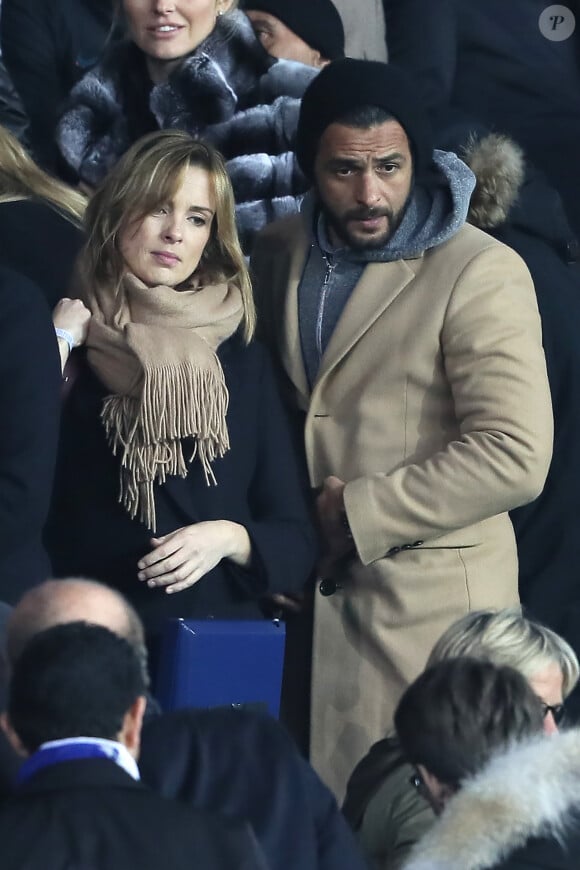 Maxim Nucci et sa compagne Isabelle Ithurburu enceinte assistent au huitième de finale retour de Ligue des Champion, du Paris Saint-Germain contre le Real Madrid au Parc des Princes à Paris le 6 mars 2018. © Cyril Moreau/Bestimage