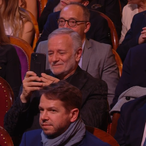 Francis Huster filmant la vidéo de son ex-femme Cristiana Reali lors de la 35e Nuit des Molières aux Folies Bergères le 6 mai 2024.