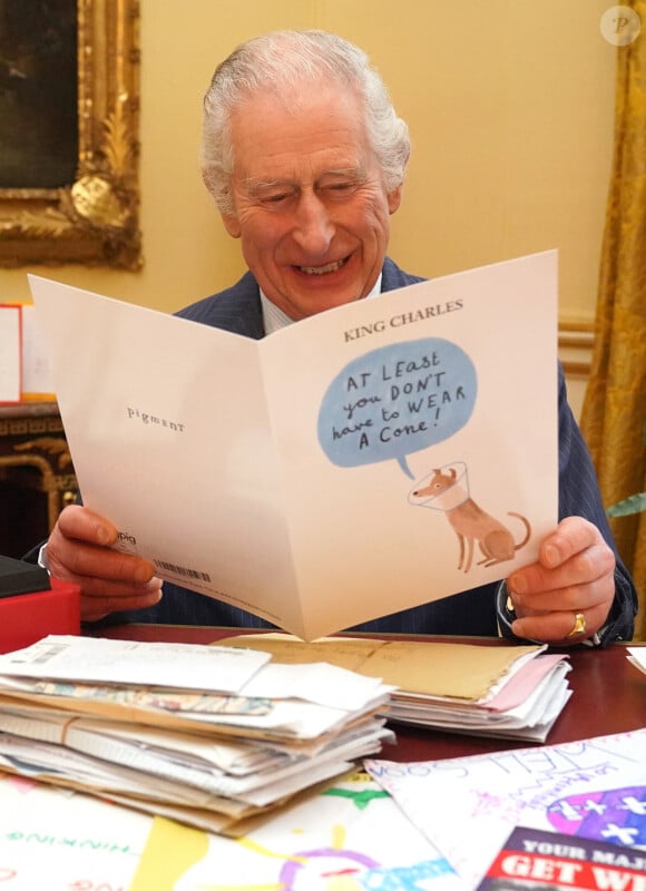 Le roi Charles III d'Angleterre, lit les messages reçus à Buckingham Palace à Londres, après le diagnostic sur son cancer, le 23 février 2024.