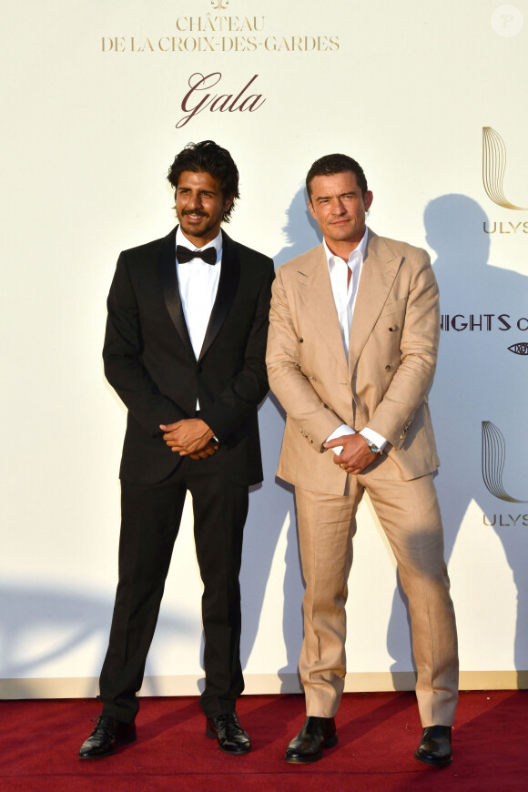 Jay Ali et Orlando Bloom - Photocall du dîner de charité "Knights of Charity" au Château de la Croix des Gardes à Cannes le 22 juillet 2024.