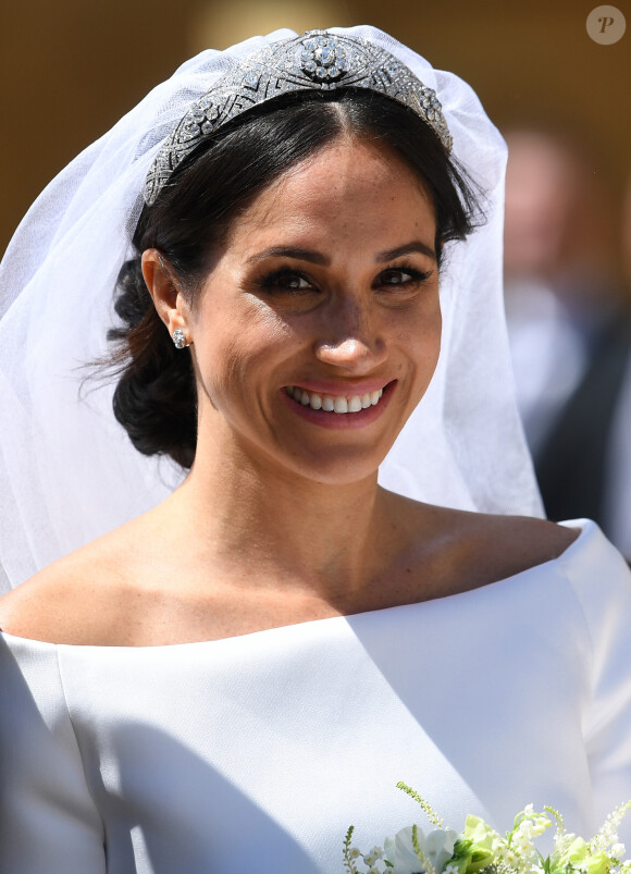 Une requête que Meghan Markle n'a pas respectée... 
Le prince Harry, duc de Sussex, et Meghan Markle, duchesse de Sussex, en calèche à la sortie du château de Windsor après leur mariage le 19 mai 2018.