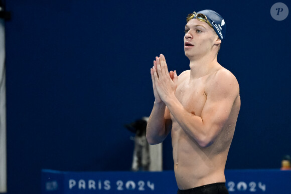 Leon Marchand of France celebrates after winning the gold medal in the swimming 200m Butterfly Men Final during the Paris 2024 Olympic Games at La Defense Arena in Paris (France), July 31, 2024.