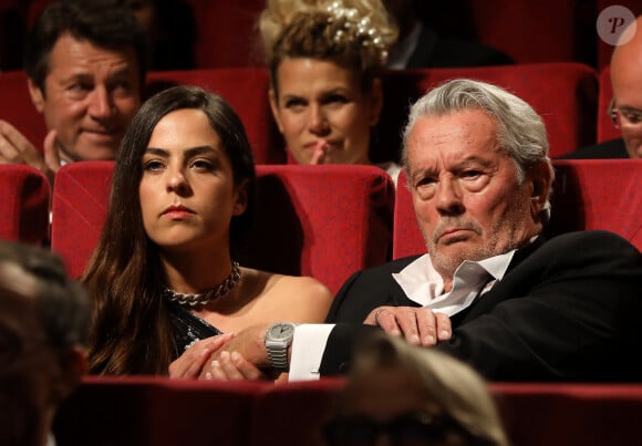 Alain Delon (avec un badge Paris Match d'une ancienne couverture du magazine titrant "Alain Delon, mes deux amours, Rosalie et Anouchka) et sa fille Anouchka (Robe Elie Saab) - Remise de la Palme d'Honneur à Alain Delon lors du 72ème Festival International du Film de Cannes. © Jacovides-Moreau / Bestimage