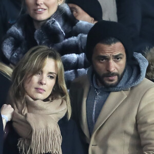 Maxim Nucci et sa compagne Isabelle Ithurburu enceinte assistent au huitième de finale retour de Ligue des Champion, du Paris Saint-Germain contre le Real Madrid au Parc des Princes à Paris le 6 mars 2018. © Cyril Moreau/Bestimage