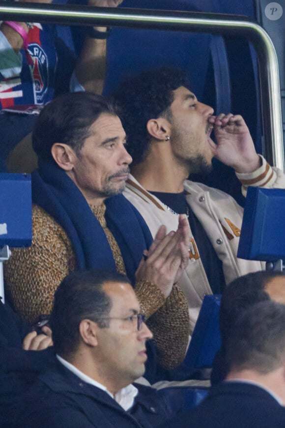 Kool Shen (Bruno Lopes) et son fils Giani Lopes dans les tribunes lors du match de Ligue Des Champions (LDC) "PSG - PSV Eindhoven (1-1)" au Parc des Princes à Paris, le 22 octobre 2024.