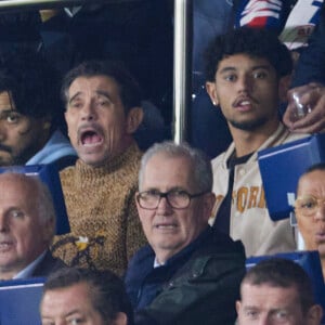 Kool Shen (Bruno Lopes) et son fils Giani Lopes dans les tribunes lors du match de Ligue Des Champions (LDC) "PSG - PSV Eindhoven (1-1)" au Parc des Princes à Paris, le 22 octobre 2024.