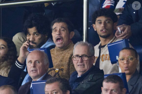 Kool Shen (Bruno Lopes) et son fils Giani Lopes dans les tribunes lors du match de Ligue Des Champions (LDC) "PSG - PSV Eindhoven (1-1)" au Parc des Princes à Paris, le 22 octobre 2024.