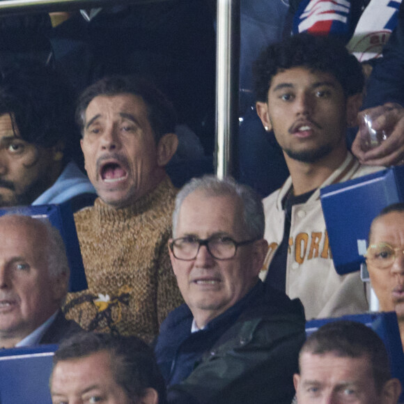 Kool Shen (Bruno Lopes) et son fils Giani Lopes dans les tribunes lors du match de Ligue Des Champions (LDC) "PSG - PSV Eindhoven (1-1)" au Parc des Princes à Paris, le 22 octobre 2024.