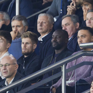 Ladji Doucouré dans les tribunes lors du match de Ligue Des Champions (LDC) "PSG - PSV Eindhoven (1-1)" au Parc des Princes à Paris, le 22 octobre 2024.