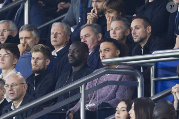 Ladji Doucouré dans les tribunes lors du match de Ligue Des Champions (LDC) "PSG - PSV Eindhoven (1-1)" au Parc des Princes à Paris, le 22 octobre 2024.