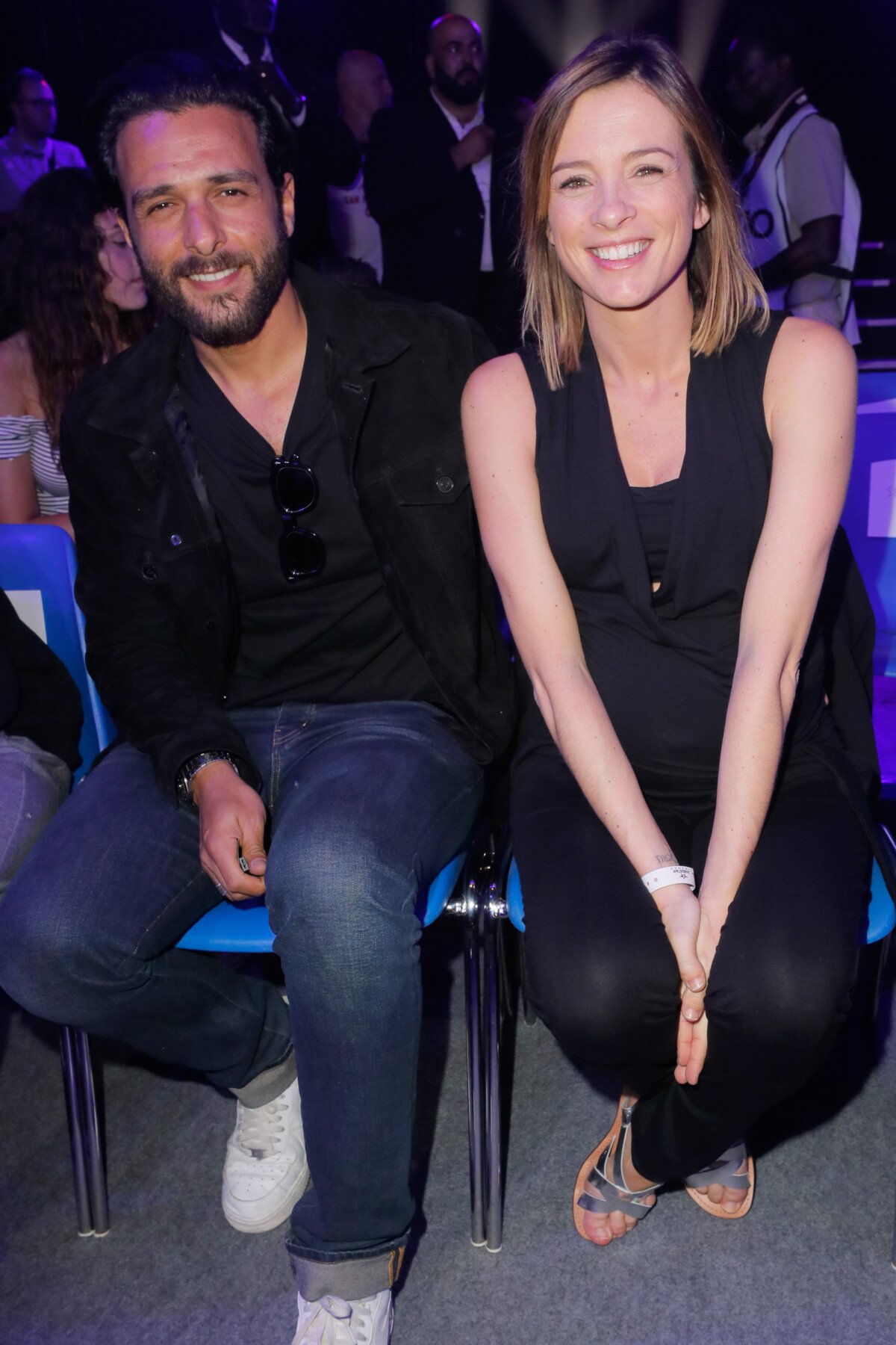 Photo : Maxim Nucci (Yodelice) et sa compagne enceinte Isabelle Ithurburu  assistent au match de boxe de Tony Yoka au palais des sports de Paris, le  23 juin 2018 © Veeren-CVS/Bestimage - Purepeople