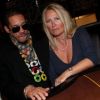 JoeyStarr et Frédérique Ruggieri, PDG de la Socodem, célèbrent l'anniversaire du site de poker en ligne MyPok le 10 mars 2012 au cercle Cadet à Paris