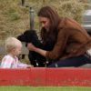 Kate Middleton, duchesse de Cambridge, assiste avec son chien Lupo à un match caritatif de polo auquel les princes William et Harry participent, à Westonbirt, le 17 juin 2012. Ici avec la petite Savannah, fille de Peter et Autumn Phillips