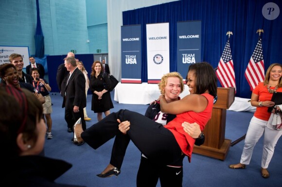 Aux Jeux olympiques de Londres, Michelle Obama rencontre la lutteuse américaine Elena Pirozhkova qui décide de soulever la first lady. Le 27 juillet 2012.