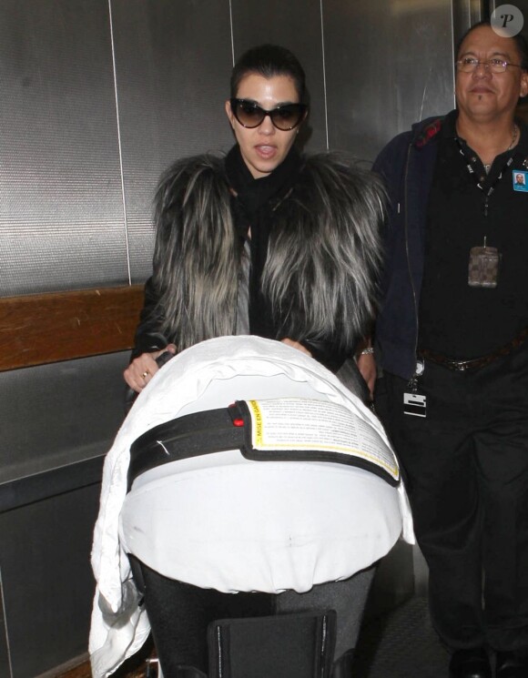 Kourtney Kardashian arrive à l'aéroport LAX de Los Angeles avec sa fille Penelope en poussette en provenance de New York. Le 16 janvier 2013.