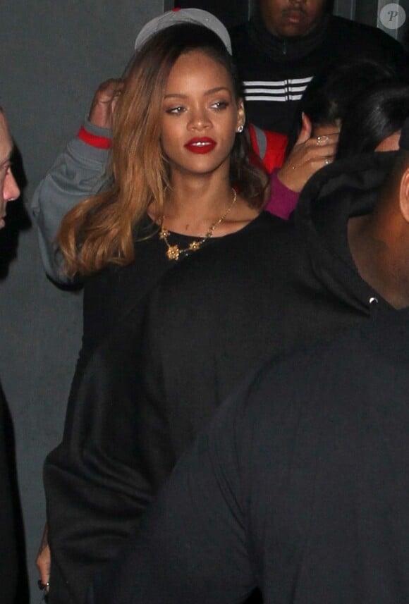 Rihanna, sublime, quitte le Playhouse, une boîte de nuit de Los Angeles, au bras de son amie Melissa, le 24 janvier 2013. Rihanna arbore une robe très courte noire transparente sans soutien-gorge sur de somptueux talons.