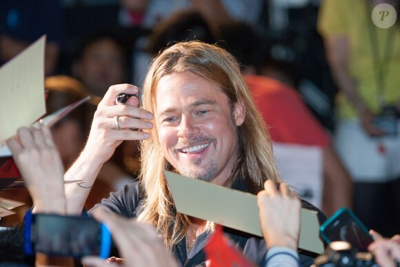 Brad Pitt accueilli à Tokyo, le 31 juillet 2013.