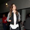Cheryl Cole arrive à l'aéroport de Los Angeles, habillée d'une veste T by Alexander Wang, d'un débardeur Rick Owens, d'un pantalon MICHAEL Michael Kors et de souliers Christian Louboutin (modèle V Neck). Le 20 octobre 2013.