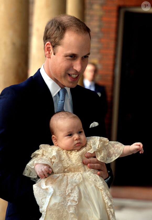 Le prince William, duc de Cambridge, et son fils le prince George, à la Chapelle Royale du palais Saint James le 23 octobre 2013
