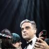 Lily Allen et Robbie Williams lors du concert de charité "Under1Roof" à Londres, le 19 décembre 2013.