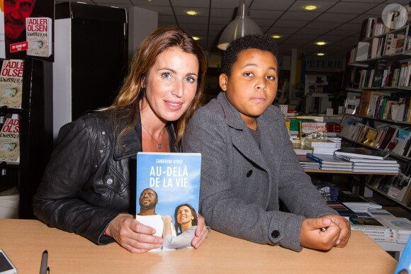 Sandrine Diouf, en présence de son fils Isaac, dédicace son livre "Au-delà de la vie", paru aux éditions Michel Lafon, à la librairie du Prado à Marseille. Le 18 janvier 2014.
