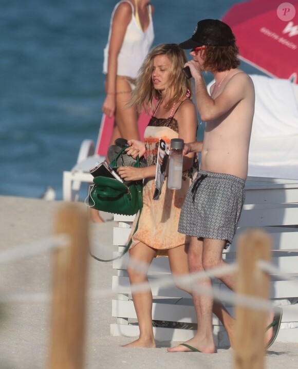 La divine Georgia May Jagger et un ami se détendent à la plage à Miami le 05/02/2014. Le top model a passé le plus clair de son temps à écouter de la musique et lire les magazines people.