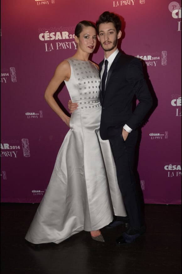 Pierre Niney, portant une montre Star classique Montblanc,  et Natasha Andrews lors de la soirée La Party des César le 28 février 2014 au VIP Room à Paris