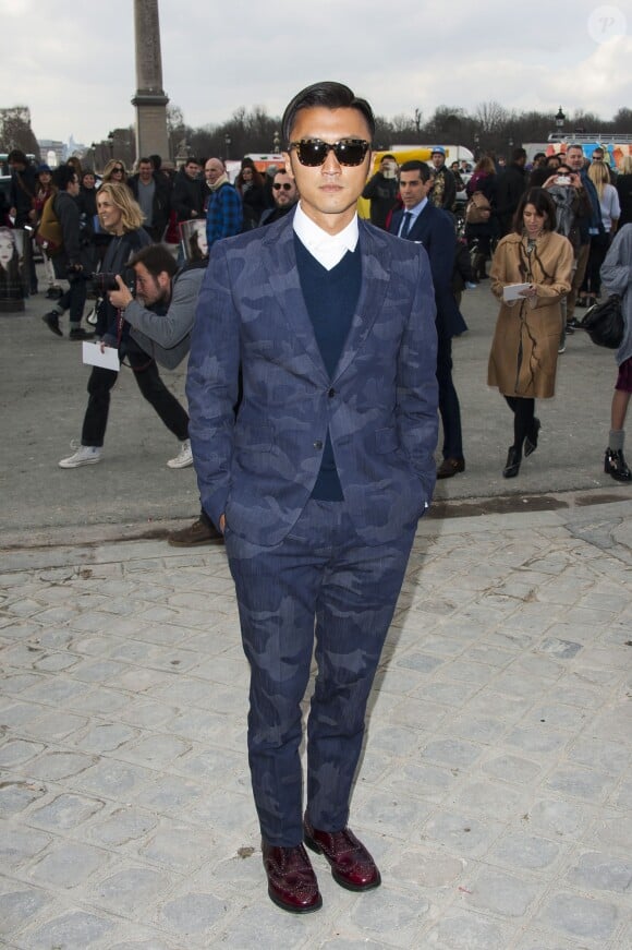 Nicholas Tse arrive au jardin des Tuileries pour assister au défilé Valentino prêt-à-porter automne-hiver 2014/2015. Paris, le 4 mars 2014.
