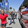 Exclusif - Nicolas Sarkozy se fait arrêter par un bus touristique du site d'infos people TMZ.com lors de son jogging à Beverly Hills, le 28 avril 2014. L'ancien président amusé par cette situation inattendue, salue les touristes et pose devant leurs objectifs.
