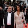 Luc Besson et Virginie Silla lors de la montée des marches du film Saint-Laurent à l'occasion du 67e Festival de Cannes, le 17 mai 2014.