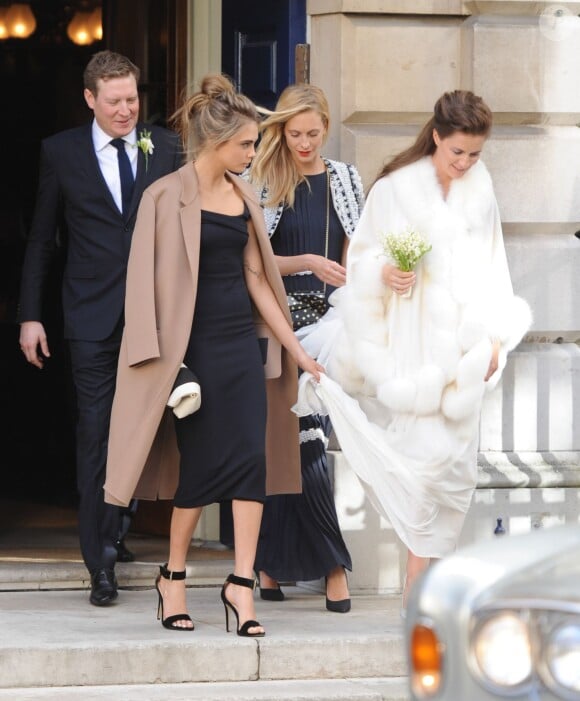 Cara et sa soeur Poppy Delevingne escortent leur soeur Chloe lors deson mariage à Londres le 7 février 2014. Les deux blondes sont devenues tantes le 11 juin 2014