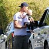 Exclusif - Josh Duhamel, pieds nus, sort de chez lui avec son fils Axl pour discuter avec un ami à Brentwood, le 12 juin 2014.