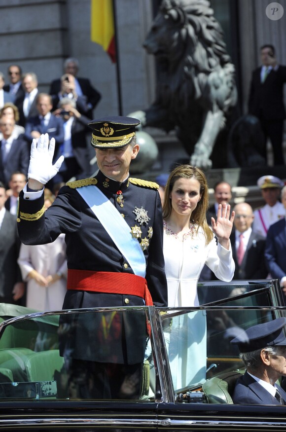 Le roi Felipe VI et la reine Letizia d'Espagne saluent la foule après la cérémonie d'investiture au parlement sur le chemin du palais royal à Madrid, le 19 juin 2014.