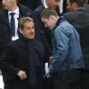 Louis Sarkozy et Nicolas Sarkozy au Stade de France pour un match du PSG en Coupe de la Ligue, le 19 avril 2014. 