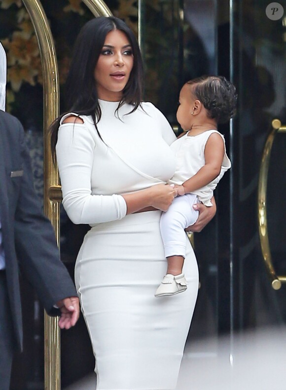 Kim Kardashian en compagnie de sa fille North à la sortie de son l'hôtel "Peninsula Beverly Hills", le 25 août 2014. 