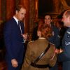 Le prince William, le prince Harry et Elizabeth II, lors de la réception en l'honneur de soldats blessés au combat et revenus à présent à la vie militaire au palais de Buckingham à Londres, le 6 novembre 2014.