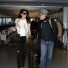 George Clooney et sa femme Amal Alamuddin arrivent à l'aéroport de Londres le 27 novembre 2014.