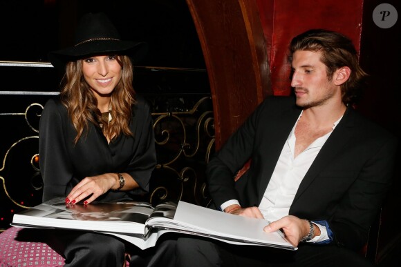 Laury Thilleman et son compagnon Nicolas Tesic à la soirée de lancement du livre "Johnny Hallyday on the road" de Renaud Corlouer au Buddha-Bar à Paris, le 18 novembre 2014.