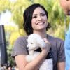 Demi Lovato se rend, accompagnée de son petit caniche blanc, à l'émission "Extra" de Mario Lopez pour une interview à Universal City, le 3 mars 2015 