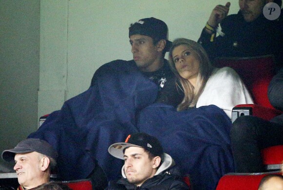 Marquinhos et sa belle fiancée Carol Cabrino, réchauffés lors du match de Ligue 1 entre le PSG et Lorient au Parc des Princes à Paris, le 20 mars 2015