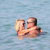Amélie Neten (Star de Secret Story 4 et des Anges de la télé-réalité) et son compagnon Philippe Leonard (ex-footballeur) en vacances à la plage l'Eden à Saint-Tropez le 11 août 2015.