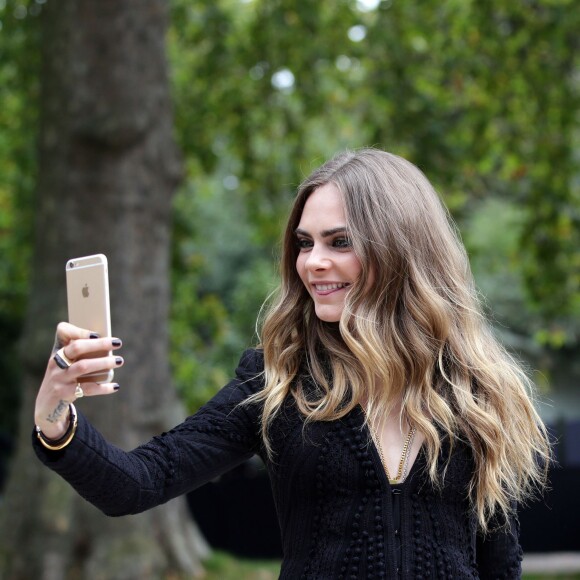 Cara Delevingne assiste au défilé Burberry Prorsum (collection printemps-été 2016) à Hyde Park. Londres, le 21 septembre 2015.