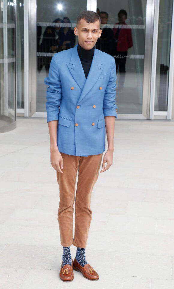 Le chanteur Stromae - Sorties du défilé de mode "Louis Vuitton", collection prêt-à-porter automne-hiver 2015/2016 à la fondation Louis Vuitton à Paris. Le 11 mars 2015