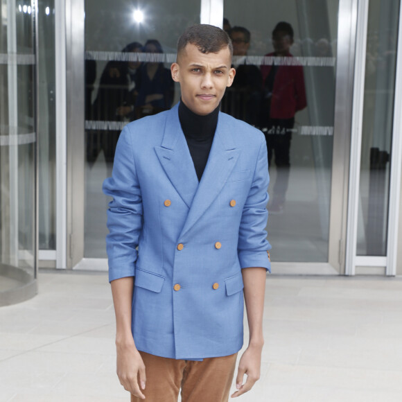 Le chanteur Stromae - Sorties du défilé de mode "Louis Vuitton", collection prêt-à-porter automne-hiver 2015/2016 à la fondation Louis Vuitton à Paris. Le 11 mars 2015