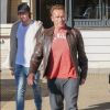 Arnold Schwarzenegger, une attelle à la jambe droite, se promène avec son fils Patrick Schwarzenegger dans les rues de Beverly Hills. Patrick s'arrête un moment pour caresser le petit caniche d’une passante. Le 20 décembre 2016