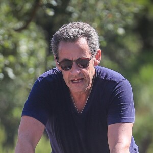 Nicolas Sarkozy fait du velo au Lavandou pendant ses vacances accompagné d'un garde du corps le 31 juillet 2016.