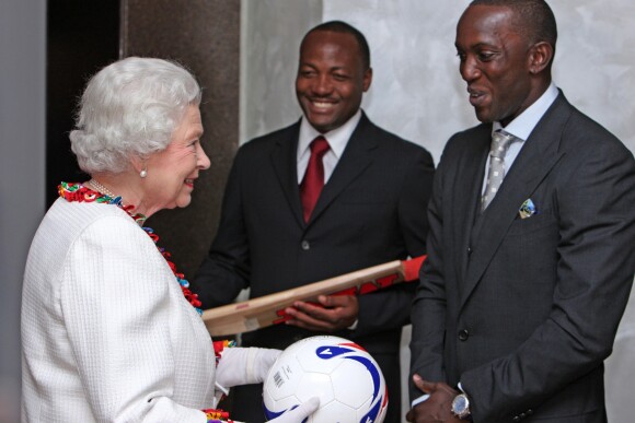Britain's Queen Elizabeth II is presented with a football from Dwight Yorke (right), former Manchester United footballer and the current team coach of Trinidad and Tobago football team and a signed cricket bat from cricketer Brian Lara (centre) during a reception at the Carlton Savana Hotel, in Port of Spain,Trinidad and Tobago, on November 28, 2009. Photo by Chris Radburn/PA Photos/ABACAPRESS.COM29/11/2009 - Port of Spain