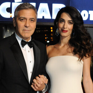 Exclusif - George Clooney (montre Omega) et sa femme Amal Alamuddin-Clooney (enceinte) - Arrivées à la 42ème cérémonie des Cesar à la salle Pleyel à Paris, le 24 février 2017.
