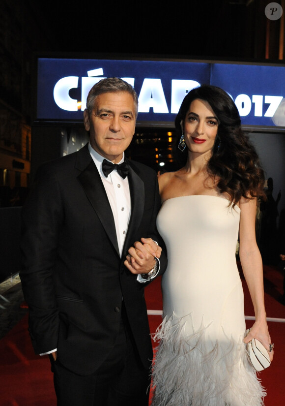 Exclusif - George Clooney (montre Omega) et sa femme Amal Alamuddin-Clooney (enceinte) - Arrivées à la 42ème cérémonie des Cesar à la salle Pleyel à Paris, le 24 février 2017.